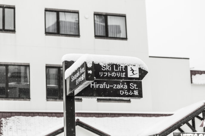 Snow covered ski lift sign.