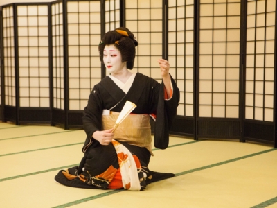 Elegant geisha seated.