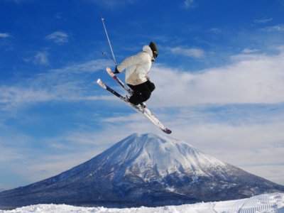 Skier jumping over mt yotei